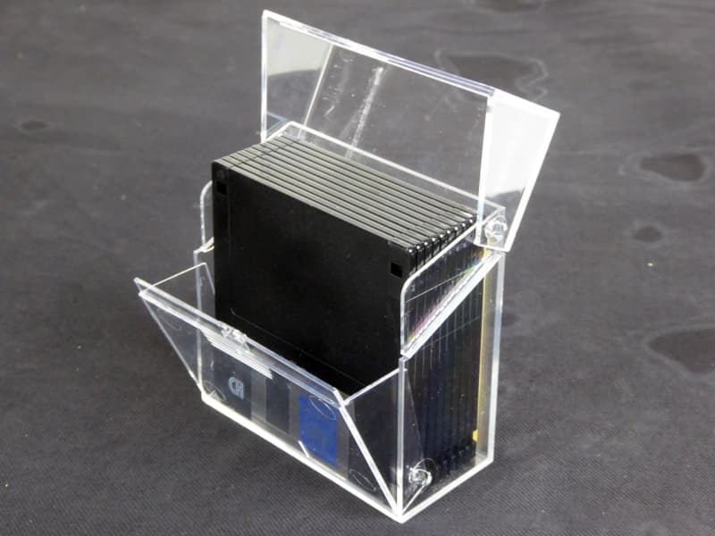 Transparent box of black 1990s computer floppy disks