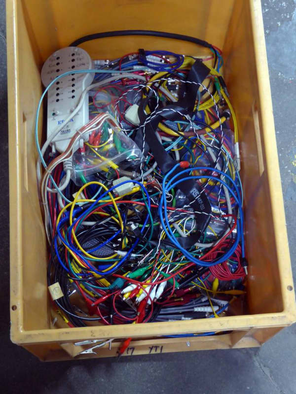 Crate of coloured laboratory/sciency style connecting wires & cables.