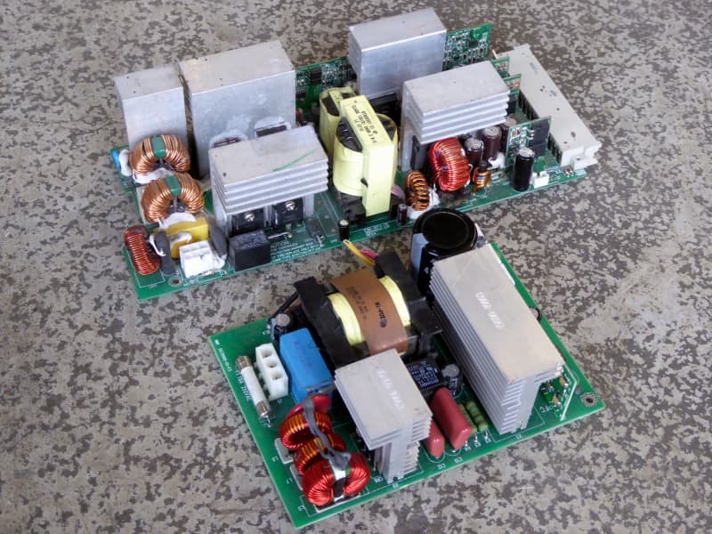 Power supply Printed Circuit Boards (PCBs) with finned heatsinks, colourful doughnut toroid copper coils