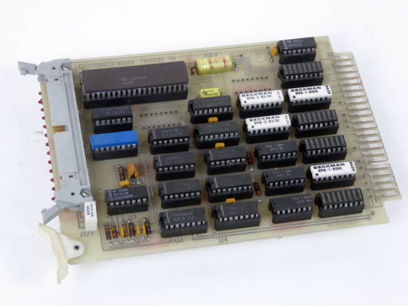 Computer chips on circuit board with gold tines & complex wiring on rear