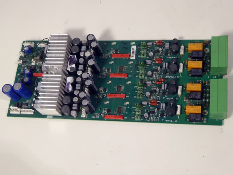Printed Circuit Board with heat sinks/coolers, cylindrical caps, coloured components