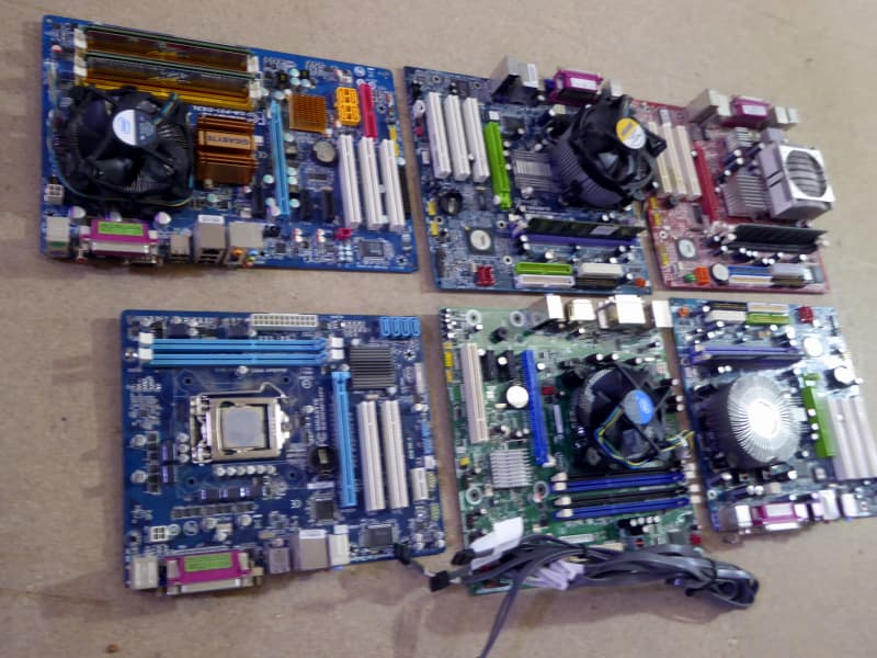 Assorted modern, colourful computer motherboards (PCBs)