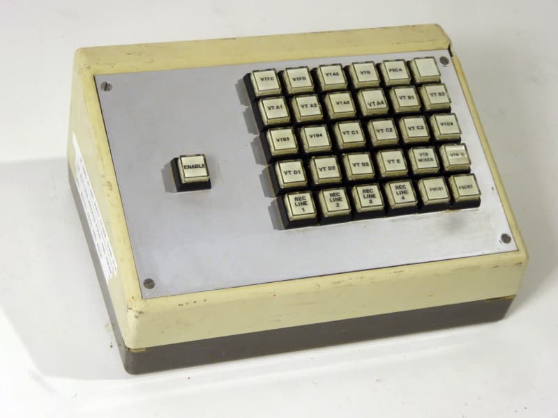 Small sloping desktop console with 5x6 matrix of square buttons