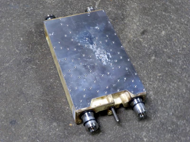 Silver plated metal slab covered in intricate fasteners