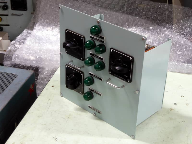 Non practical navy control panel with large domed green lamps & chunky rotary switches