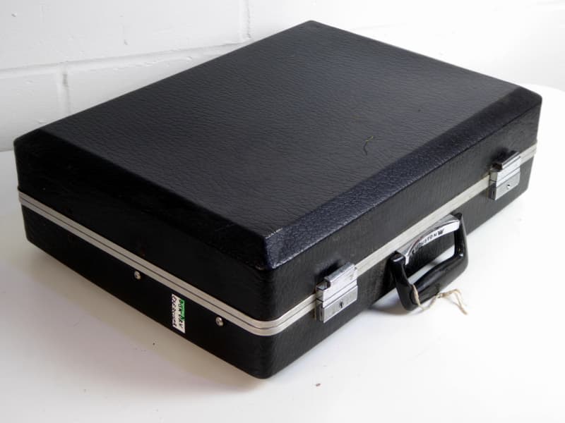 Black suitcase with technical control panel, chunky rainbow ribbon cable, buttons, LEDs etc