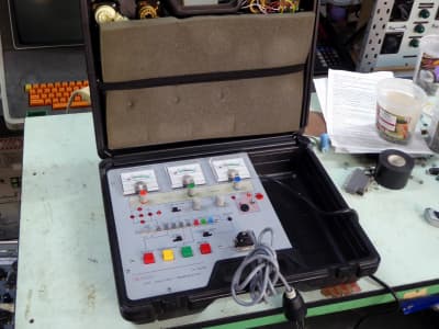 Practical control panel with meters, knobs, LEDs, coloured switches in ruggedised case