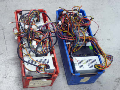 5x Computer power supplies with coloured wires in fibre board crate
