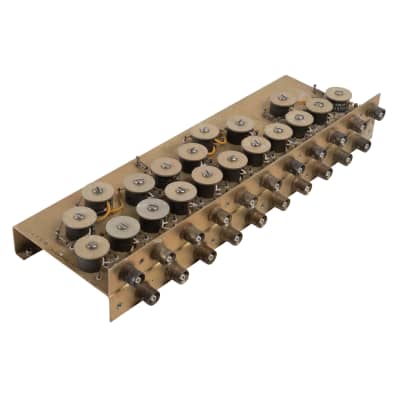 Bronzy coloured detailed metal chassis with repeating metal disks & round sockets