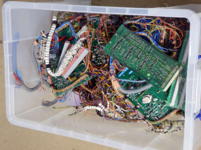 Large crate of mixed Printed Circuit Boards (PCBs) with attached colourful wiring looms