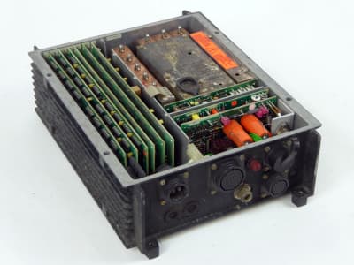 Exposed, open, hi-tech military radio transceiver in finned black case