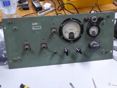 Period control panel in muddy green with knobs, switches & analogue meter