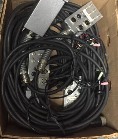 Crate of thick black chunky cables with technical control boxes & connectors