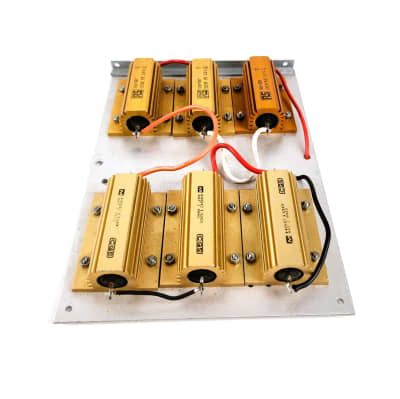 Goldy coloured power resistors on a heat sink with connecting wires