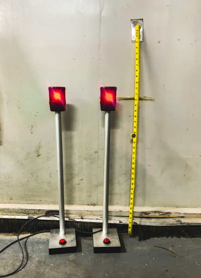 Flashing red beacon lights on poles