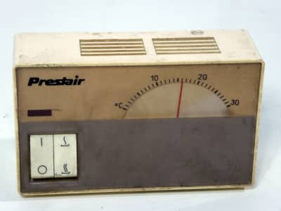 1970s domestic wall thermostat with rotary dial, switches
