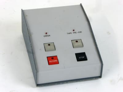 Sloping top grey console with 4 square push buttons
