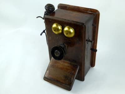 Vintage wooden wall-mount telephone. Separate earpiece, visible gongs & crank to call handle