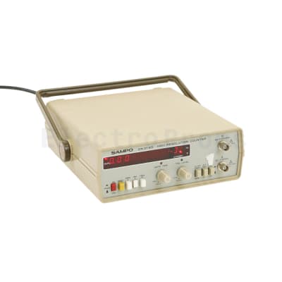 Electronics lab digital frequency counter with red numbers