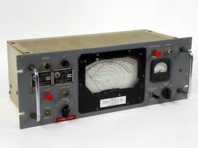Battleship grey military control panel with analogue meters, knobs