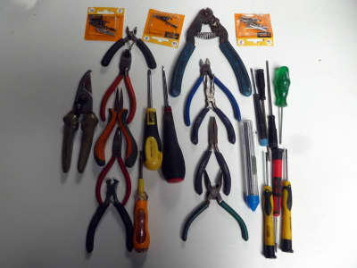Assorted miniature electronics tools - cutters, pliers, screwdrivers