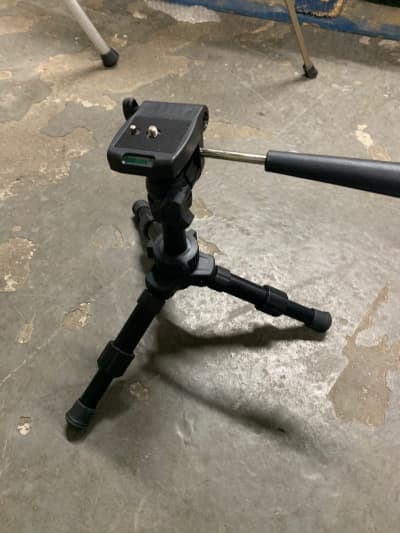 Small black desktop camera tripod