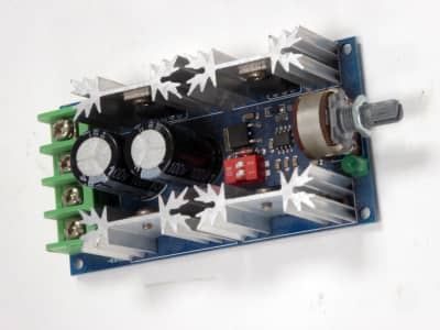 Blue motor control Printed Circuit Board with aluminium starburst heatsinks / coolers