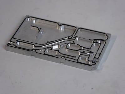 Intricately machined aluminium slab with shaped compartments