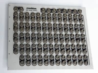 Silver Maddox patch panel with dense matrix of 138 BNC sockets