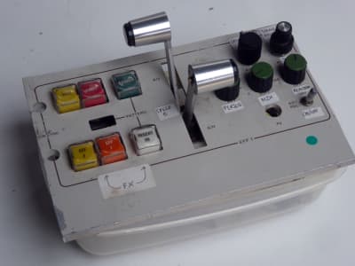 Small white control panel with square buttons & twin T-handle lever faders