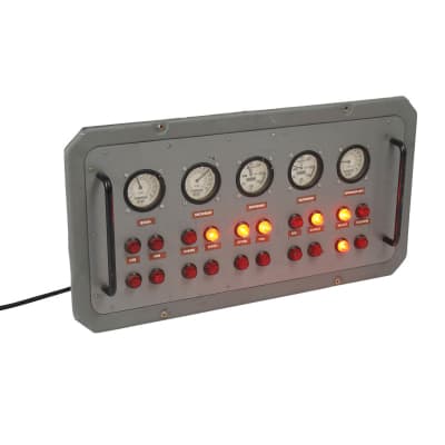 Grey panel with analogue meters and red lights 