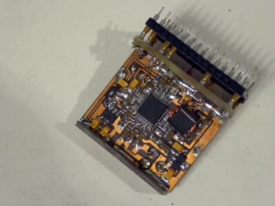 Miniature bare copper Printed Circuit Board with flat pack IC