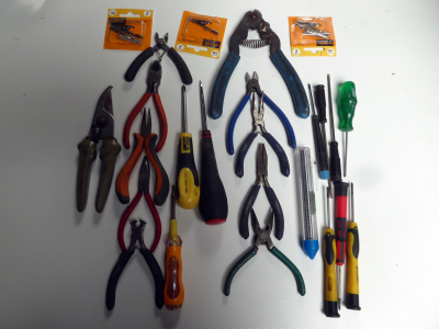 Assorted miniature electronics tools - cutters, pliers, screwdrivers