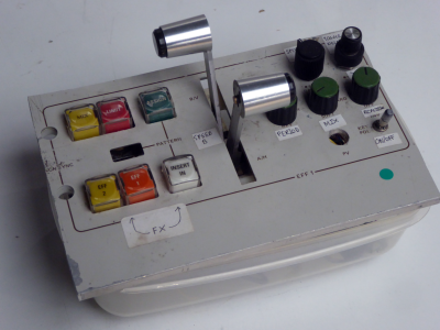 Small white control panel with square buttons & twin T-handle lever faders