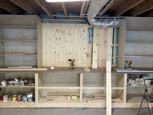 Bookshelves and TV nook, complete with water access panel