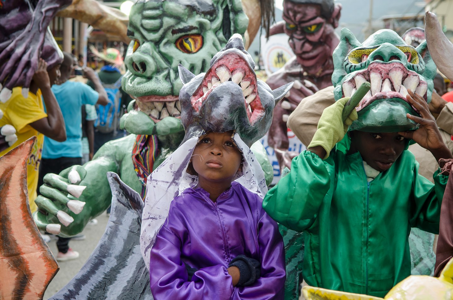 Children wearing colorful monster costumes during a festive celebration