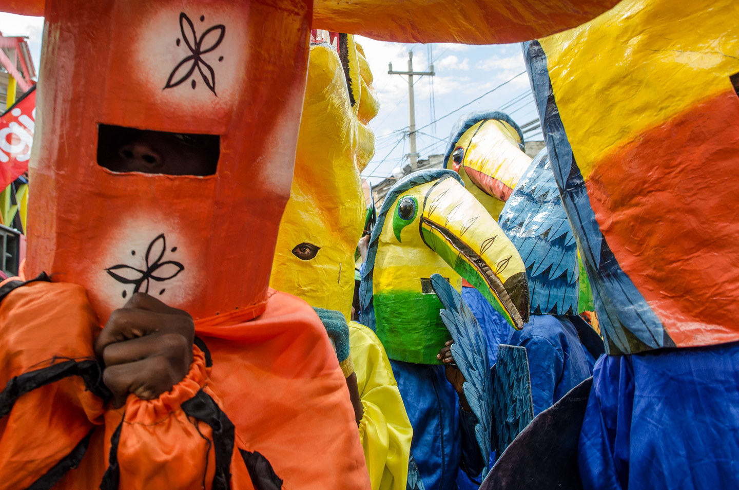 People wearing colorful masks and costumes at a festival celebration
