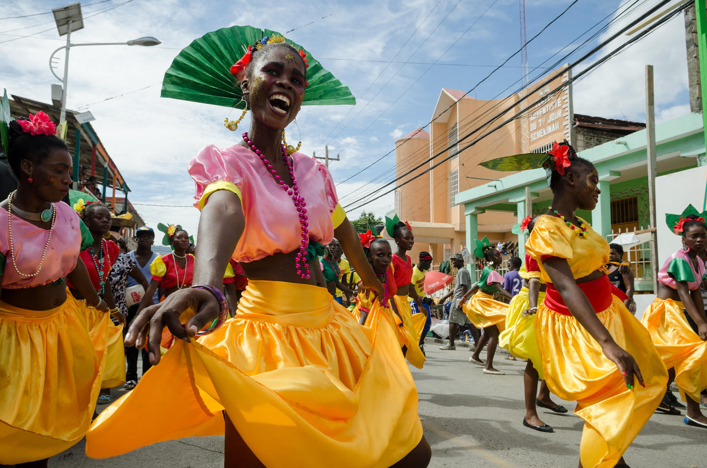 Colorful dancers in bright outfits celebrating in a lively street parade