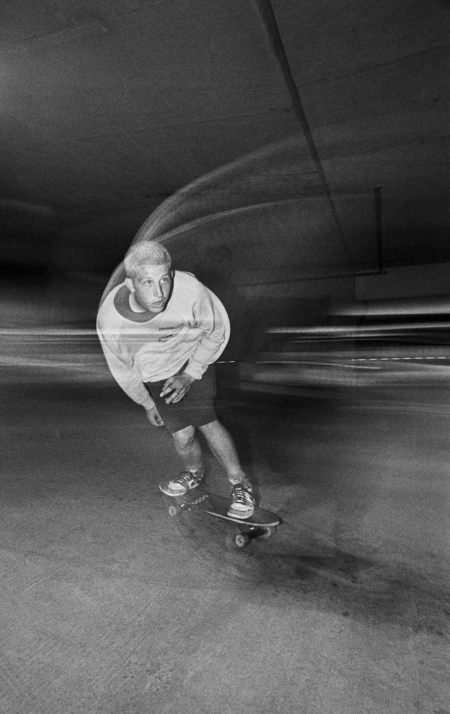 Skateboarder in motion captured in a low light environment