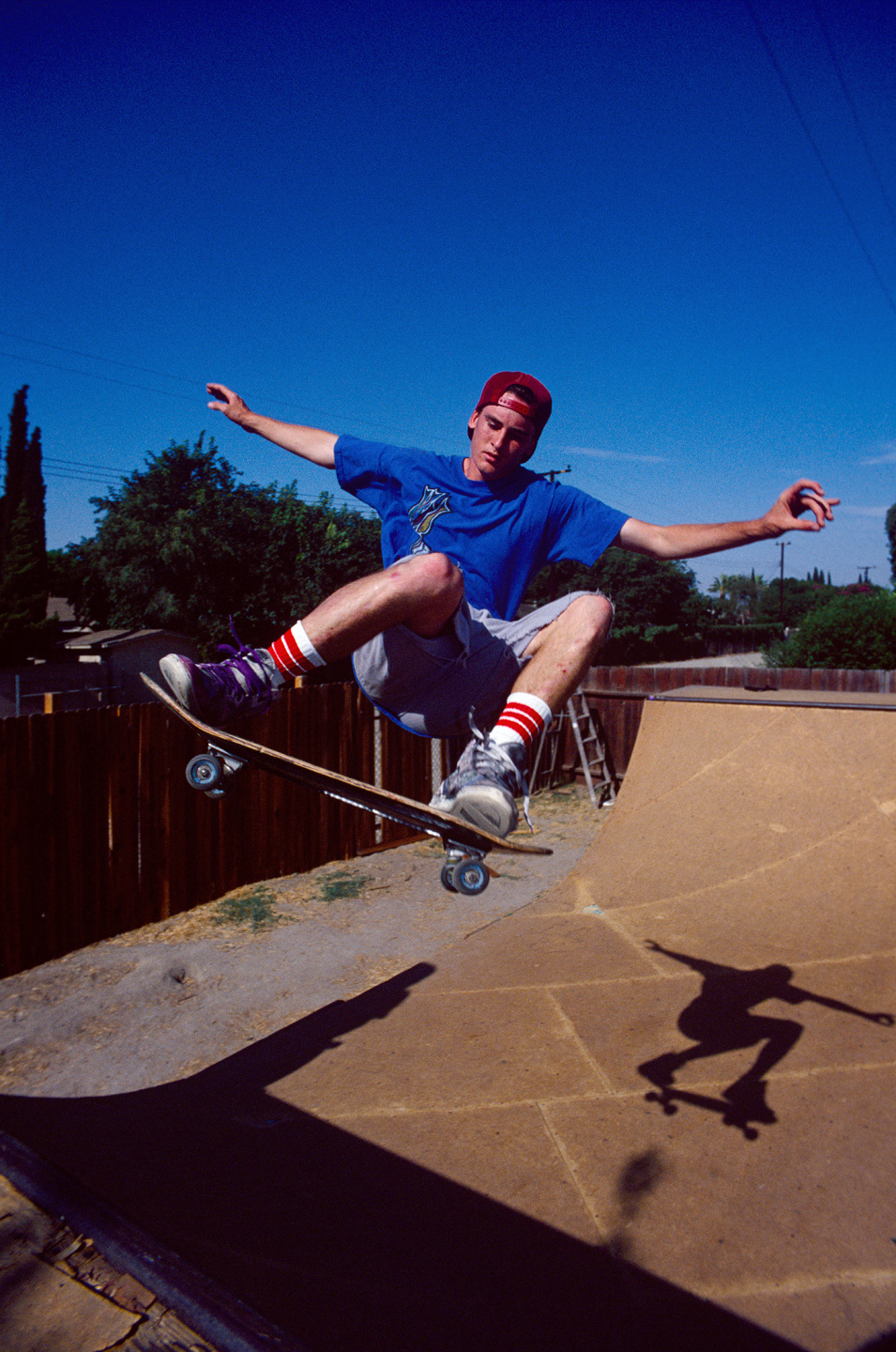 Skateboarder performing a trick in a half-pipe