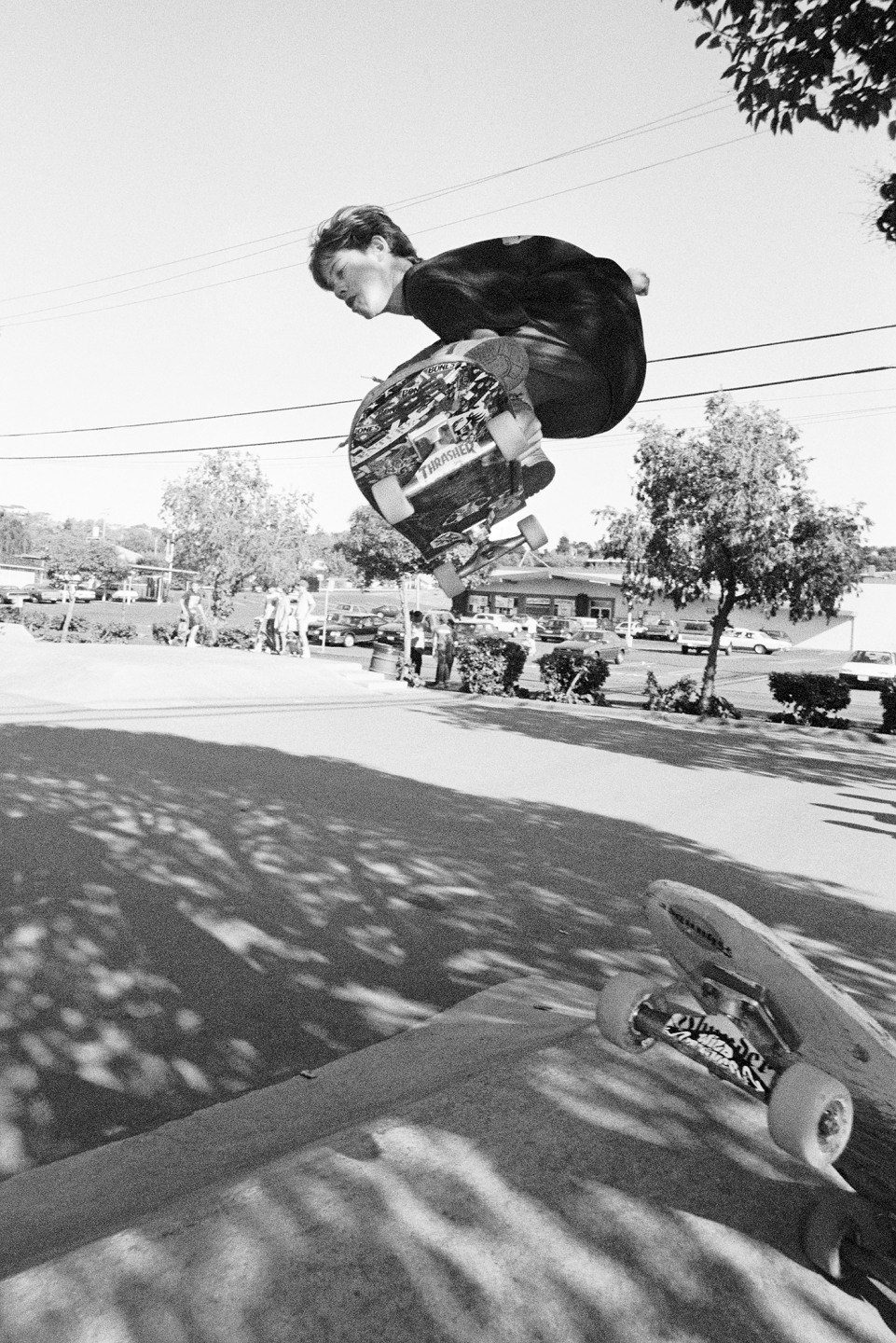 A skateboarder performing a jump mid-air in a park setting