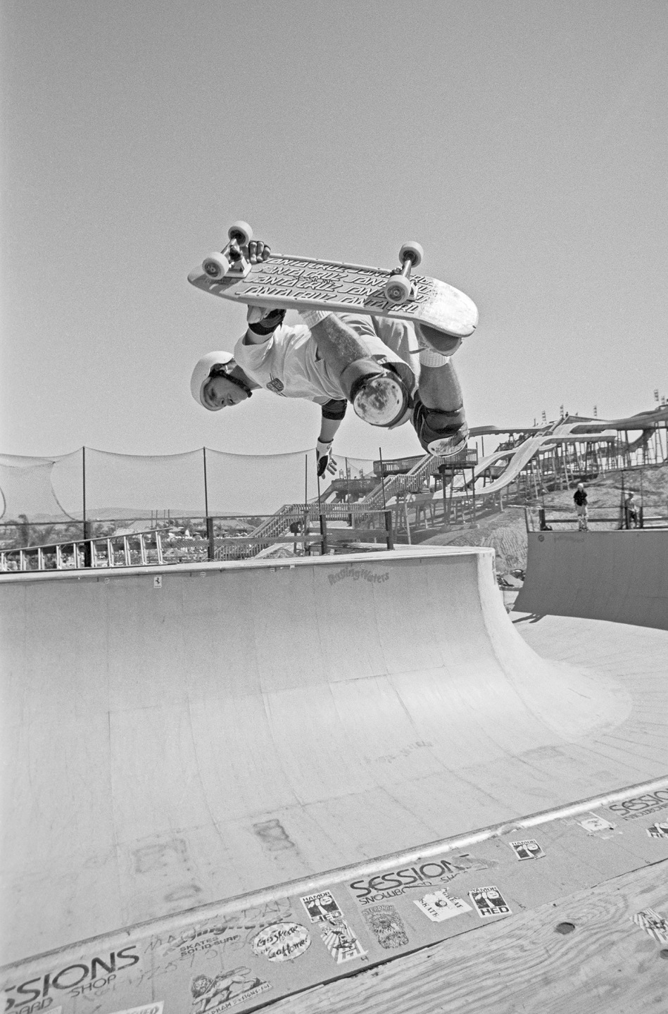 Skateboarder performing an aerial trick in a half-pipe