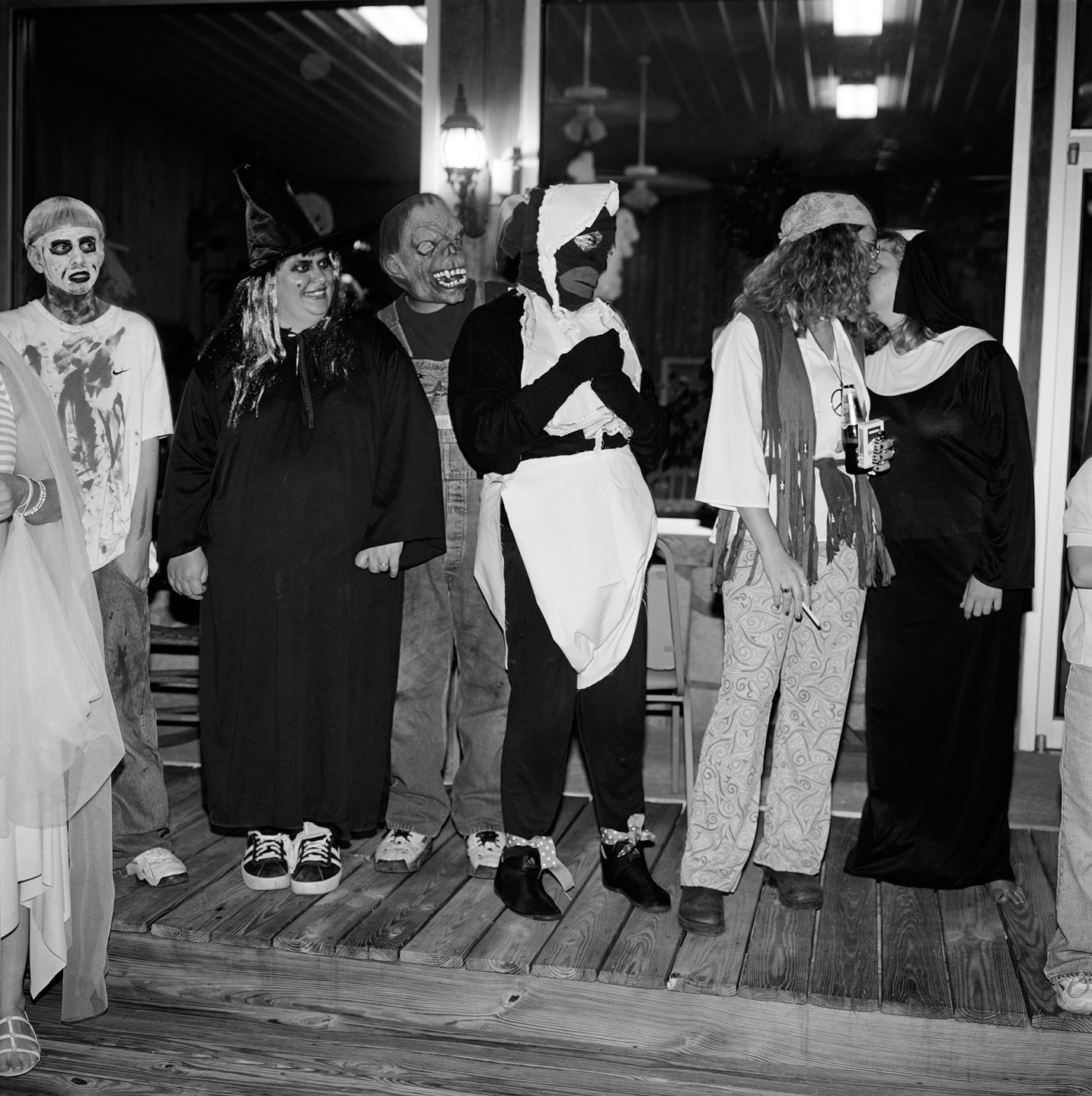 A group of people in various Halloween costumes standing together