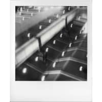 A blurred overhead view of a tiled surface with soft glowing lights
