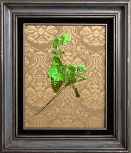A framed artwork featuring a green abstract figure against a patterned background