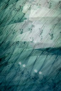 Water droplets on light green glass