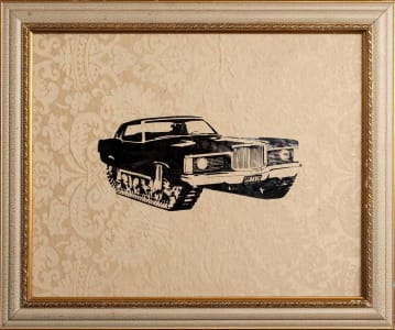 Black car with tracks artwork in a decorative frame