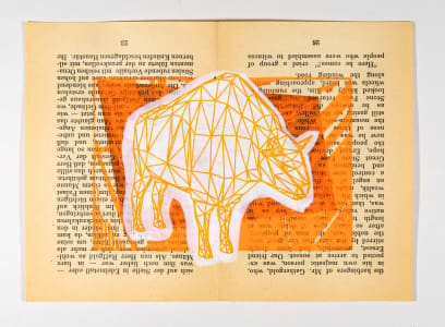 A geometric illustration of a cow on a vintage book page with an orange background