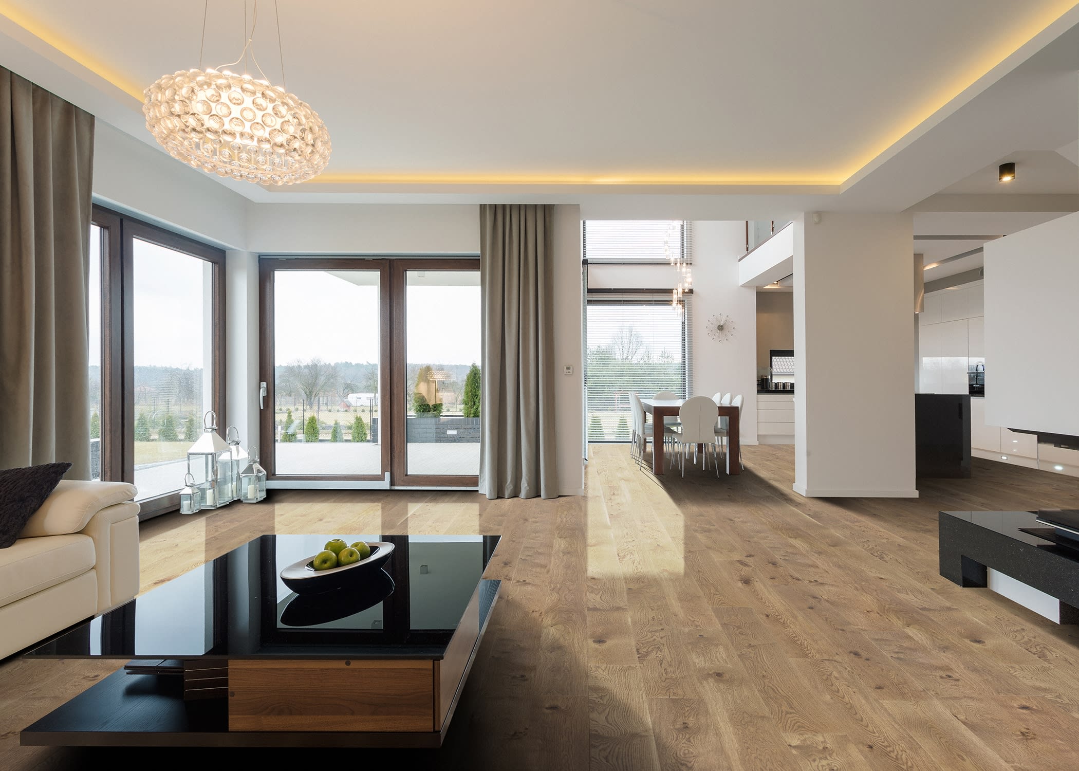 This modern living room features recessed lighting, chandelier, sleek black coffee table, and Madrid White Oak Engineered Hardwood Flooring from LL Flooring.