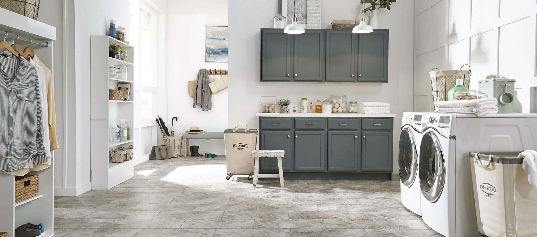 Stone look vinyl flooring in a bright laundry room.